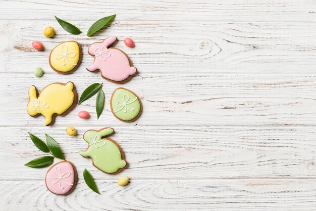 Holiday preparation Multi colors Easter eggs with cookies on colored background Pastel color Easter eggs holiday concept with copy space