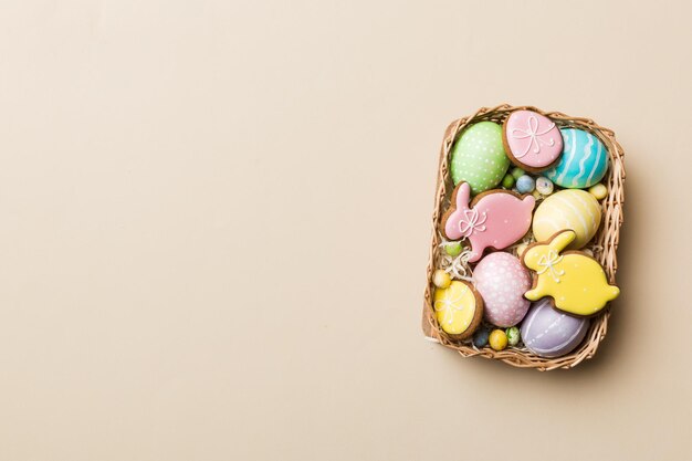 Holiday preparation Multi colors Easter eggs with cookies on colored background Pastel color Easter eggs holiday concept with copy space