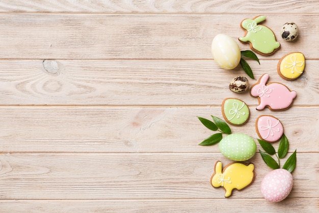 Holiday preparation Multi colors Easter eggs with cookies on colored background Pastel color Easter eggs holiday concept with copy space