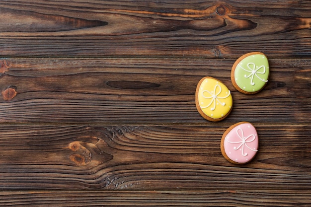 Holiday preparation Multi colors Easter eggs with cookies on colored background Pastel color Easter eggs holiday concept with copy space