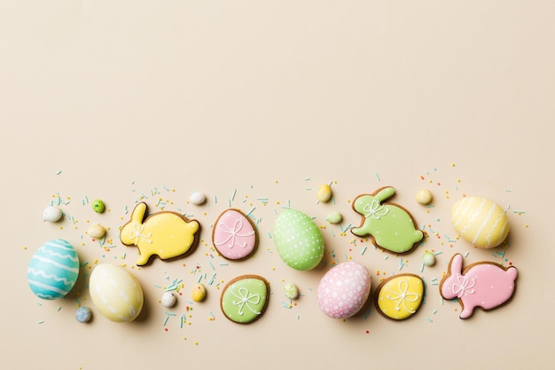 Holiday preparation Multi colors Easter eggs with cookies on colored background Pastel color Easter eggs holiday concept with copy space