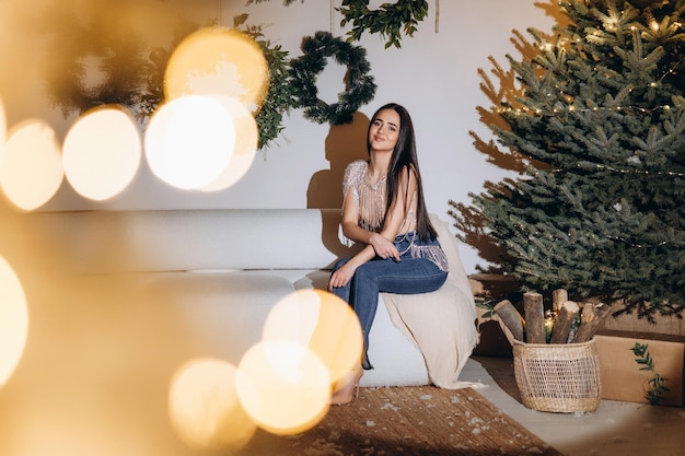 Holidays celebration and people concept smiling woman over christmas tree background