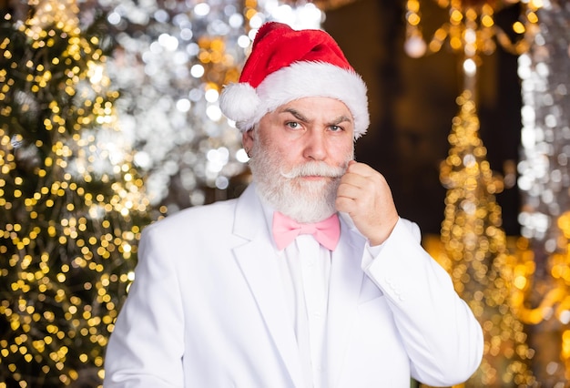 Holidays celebration Senior man with beard Best wishes Congratulations Bearded grandfather man celebrate christmas Christmas eve Santa Claus Elegant grandpa in suit Christmas corporate