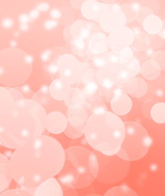 Holidays and design concept.  Abstract background. Image with blurred bokeh lights in trendy living coral color