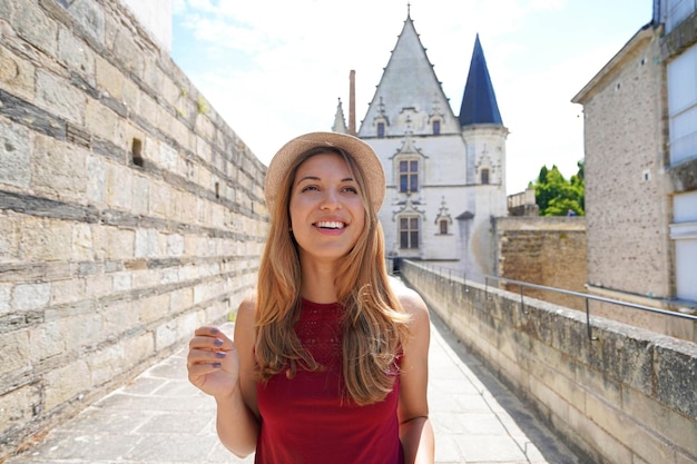 Holidays in France Portrait of excited traveler girl looks up visiting Nantes Castle France