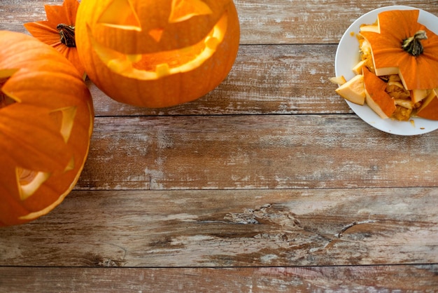 holidays, halloween and decoration concept - close up of pumpkins on table