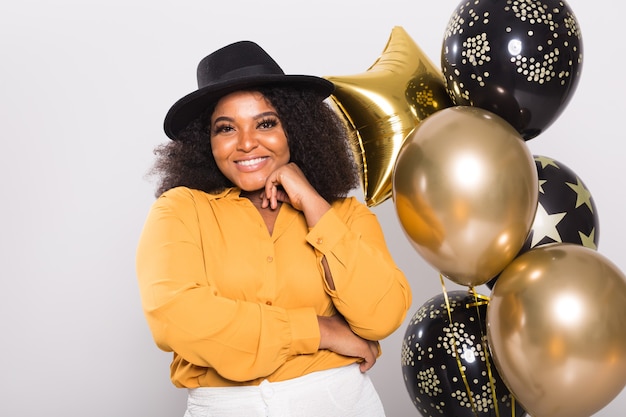 Holidays, party and fun concept - Portrait of smiling young African-American young woman looking