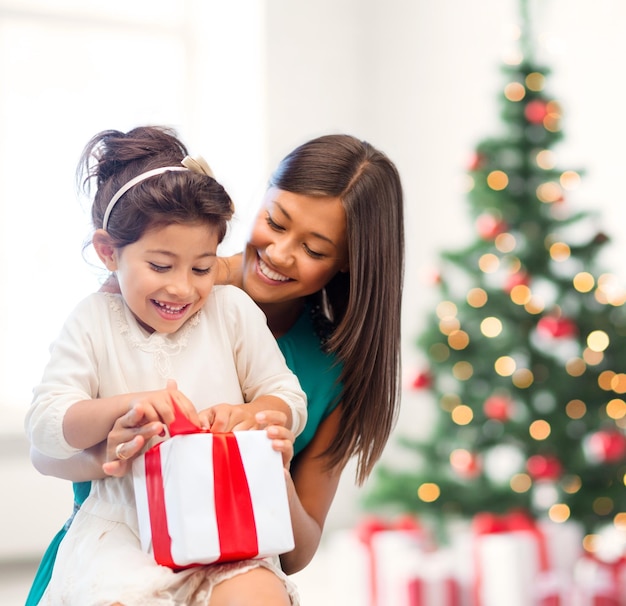 holidays, presents, christmas, x-mas, birthday concept - happy mother and child girl with gift box