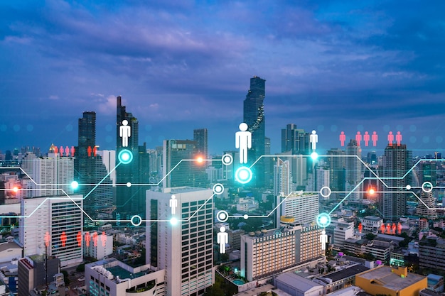 Hologram of social media icons over sunset panoramic cityscape of Bangkok Asia The concept of people connections Multi exposure