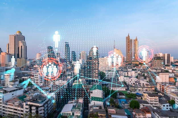 Hologram of social media icons over sunset panoramic cityscape of Bangkok Asia The concept of people connections Multi exposure