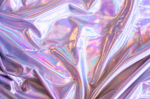 Holographic iridescent mermaid foil texture background. Futuristic neon trendy silver colors