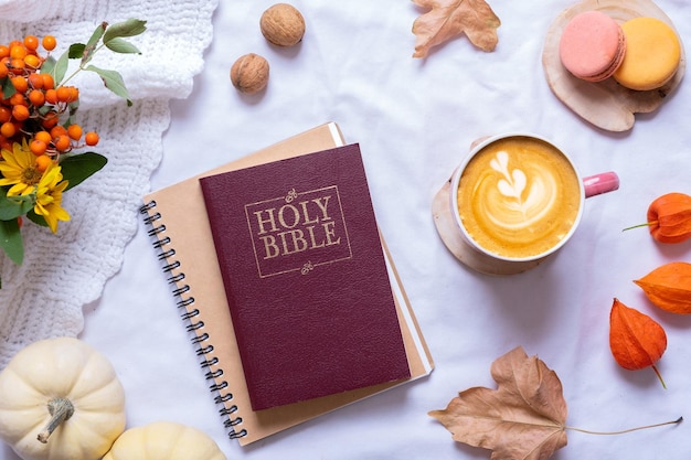 Holy Bible with cup of coffee and autumn cozy decor top view Bible study fall concept