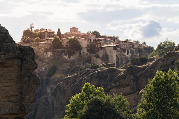 Holy Monastery of Great Meteoron on steep rock under evening light, pilgrimage destination in Greece