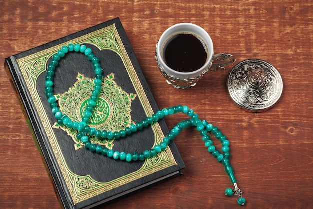 Holy Quran with beads over wooden