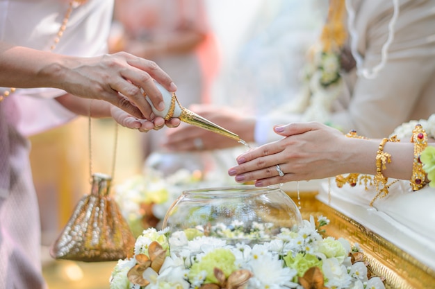 Holy water pouring ceremony for bride and groom Thai wedding engagement