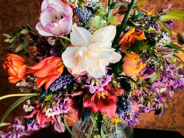 Home decor and the art of arranging bouquets Bouquet of colorful garden flowers The composition includes tulips daffodils muscari lunaria fritillaria and hellebore