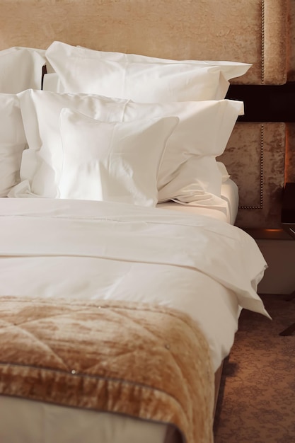 Home decor and interior design bed with white bedding in luxury bedroom bed linen laundry service and furniture detail