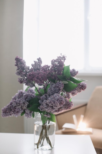 Home interior decor bouquet of lilacs in a vase on table