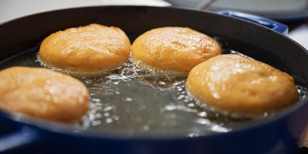 Home made doughnuts frying in oil