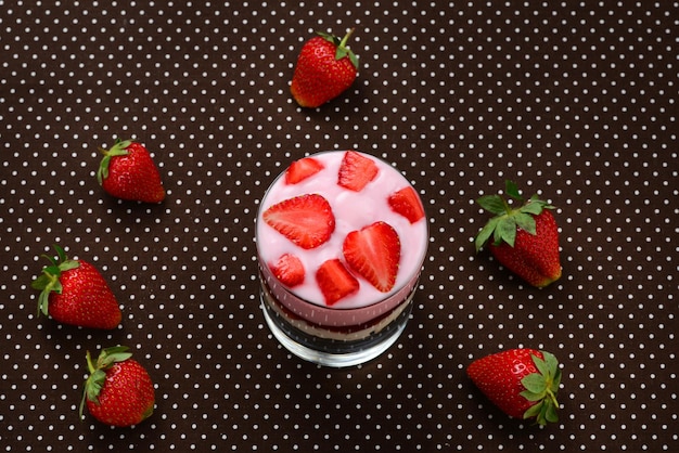 Home made granola breakfast with strawberries and plain yogurt, served in the glass.