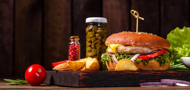 Home made hamburger with lettuce and cheese. Close-up of home made tasty burgers on wooden table