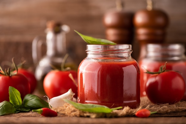 Home made tomato sauce in a jar on a wooden table