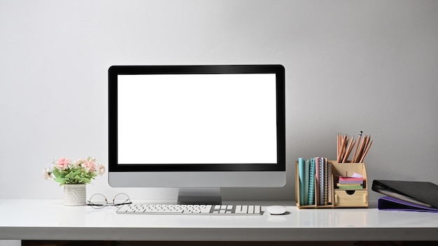 Home office desk with computer flower pot and stationery Blank screen for your advertise text