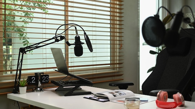 Home studio with professional condenser microphone laptop and headphone Entertainment podcasts and technology concept