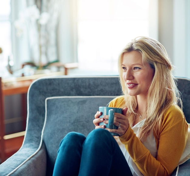 Photo home thinking and woman with coffee lounge and relax in weekend daydreaming and break in sofa house couch and person with tea peace and smile for rest in living room drink and happiness