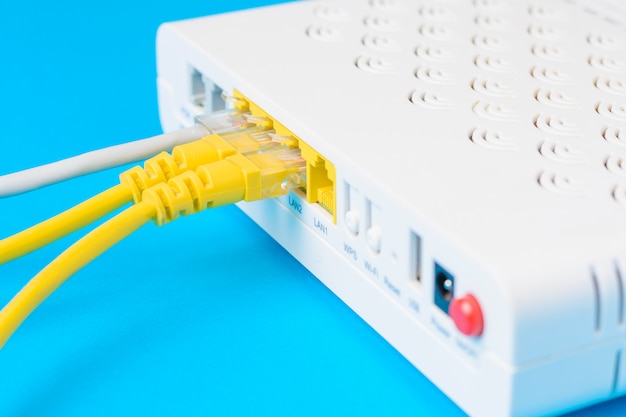 Home wireless router with ethernet cables plugged in, closeup