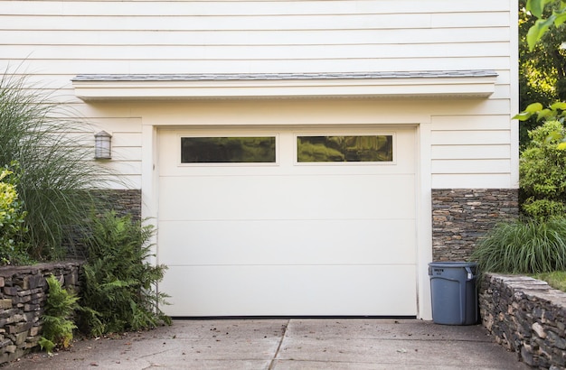 A home with a garage door that says " welcome to the community ".