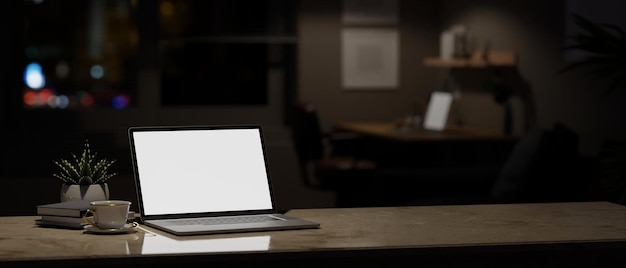 Home workspace at night with laptop mockup and copy space on a table in a dark room