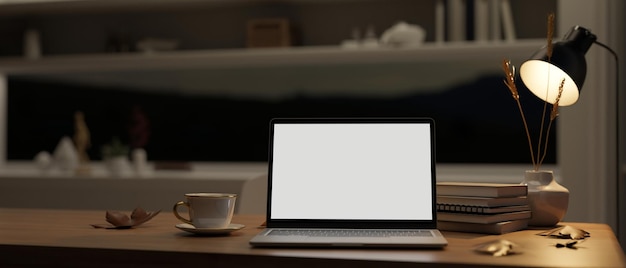 Home workspace at night with laptop mockup and stuff on a wooden table