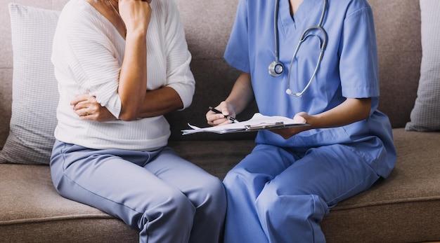 Homecare nursing service and elderly people cardiology healthcare Close up of young hispanic female doctor nurse check mature caucasian man patient heartbeat using stethoscope during visit