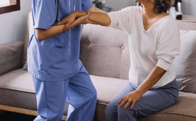 Homecare nursing service and elderly people cardiology healthcare Close up of young hispanic female doctor nurse check mature caucasian man patient heartbeat using stethoscope during visit