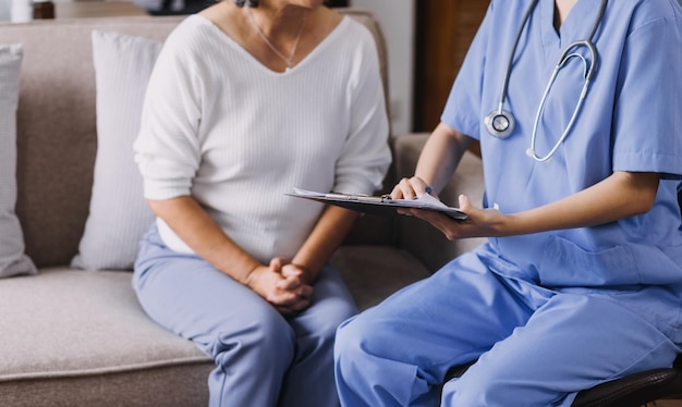 Homecare nursing service and elderly people cardiology healthcare Close up of young hispanic female doctor nurse check mature caucasian man patient heartbeat using stethoscope during visit