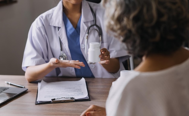 Homecare nursing service and elderly people cardiology healthcare Close up of young hispanic female doctor nurse check mature caucasian man patient heartbeat using stethoscope during visit