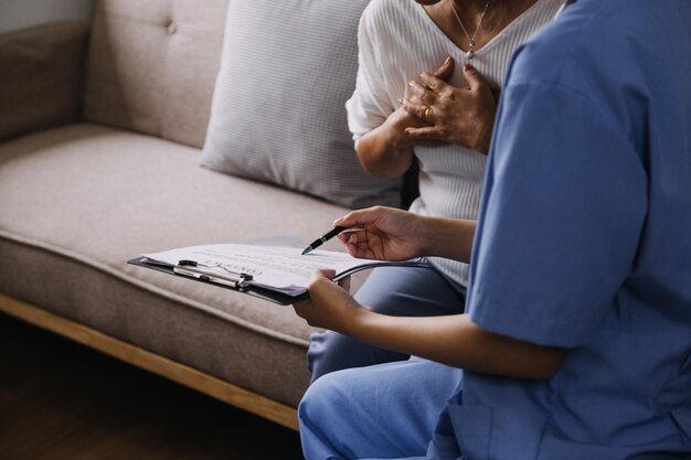 Homecare nursing service and elderly people cardiology healthcare Close up of young hispanic female doctor nurse check mature caucasian man patient heartbeat using stethoscope during visit