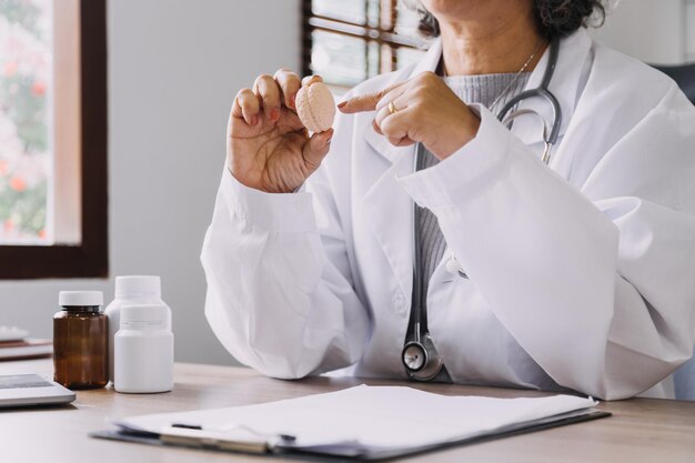 Homecare nursing service and elderly people cardiology healthcare Close up of young hispanic female doctor nurse check mature caucasian man patient heartbeat using stethoscope during visit