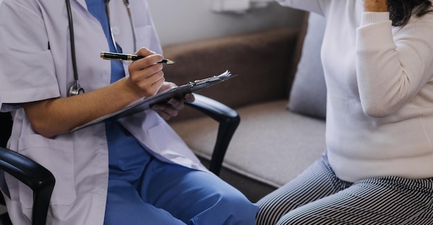 Homecare nursing service and elderly people cardiology healthcare Close up of young hispanic female doctor nurse check mature caucasian man patient heartbeat using stethoscope during visit