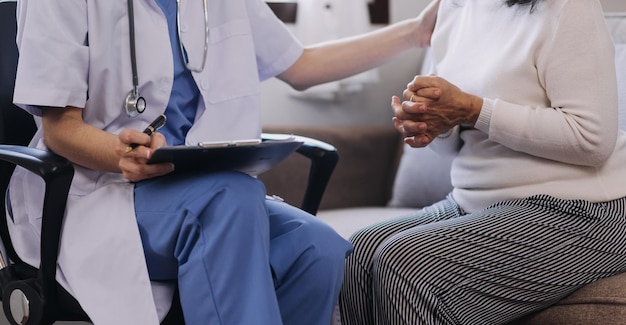 Homecare nursing service and elderly people cardiology healthcare Close up of young hispanic female doctor nurse check mature caucasian man patient heartbeat using stethoscope during visit