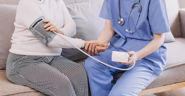 Homecare nursing service and elderly people cardiology healthcare Close up of young hispanic female doctor nurse check mature caucasian man patient heartbeat using stethoscope during visit