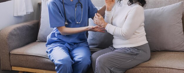 Homecare nursing service and elderly people cardiology healthcare Close up of young hispanic female doctor nurse check mature caucasian man patient heartbeat using stethoscope during visit