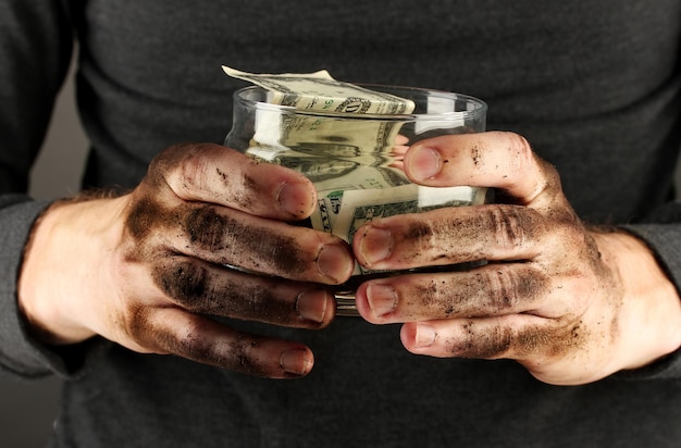 Homeless holds bank with money closeup