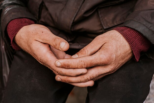 Homeless man holding his hands