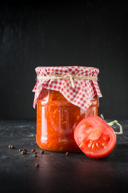 Homemade adjika with tomatoes in jar 