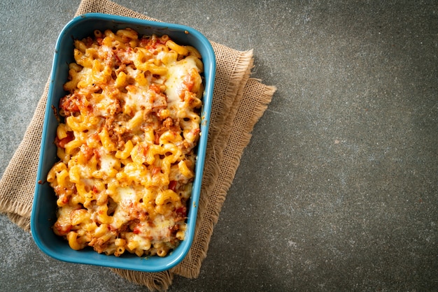 homemade baked macaroni bolognese with cheese - Italian food style