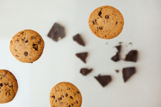 Homemade bakery and dessert chocolate cookies flying  Chocolate chip cookie with crumbs on gray