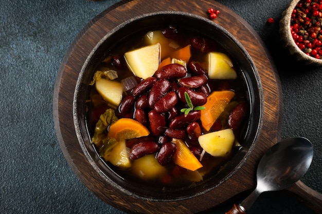 Homemade bean soup with ingredients horizontal view from above Ribolita Vegetarian soup Bean stew Eintopf soup Beans ragout