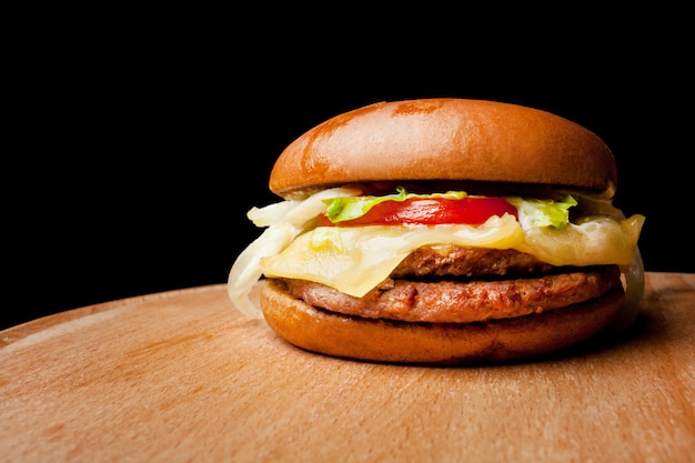 Homemade beef burger on a wooden background Fresh tasty burger with french fries on wooden table